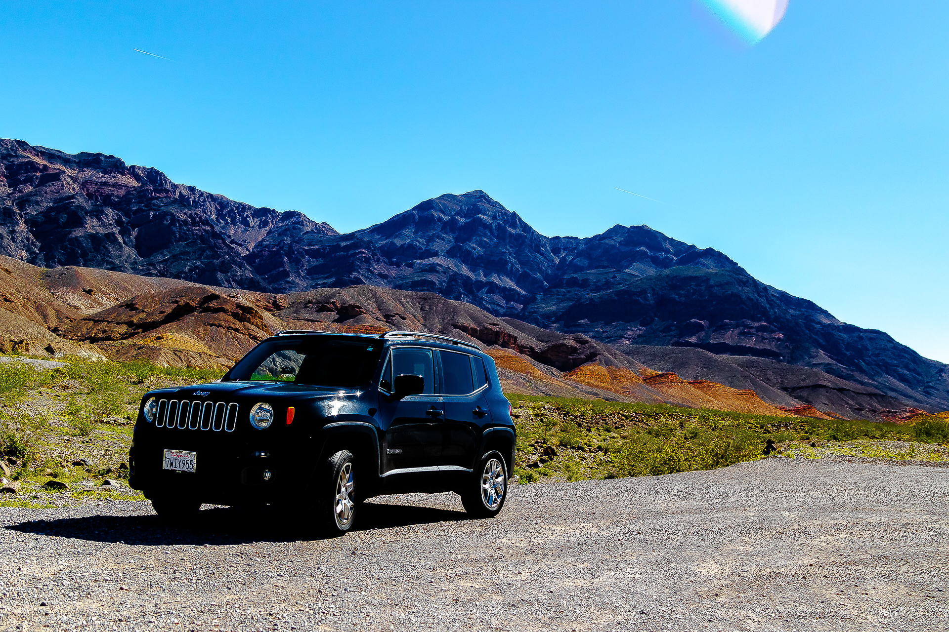 Desert base camp — Jeep Renegade parked beneath the colorful mineral hills of Death Valley